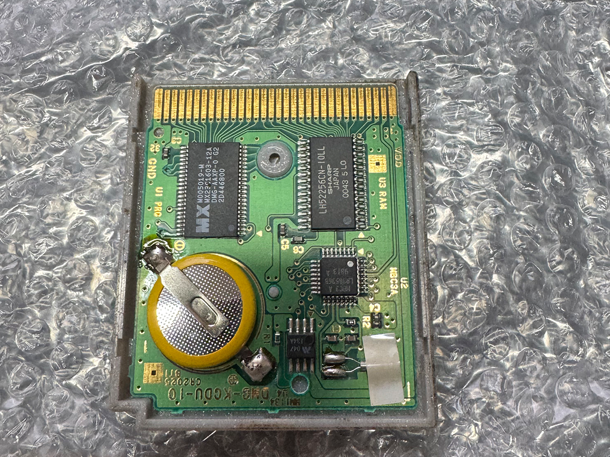Close-up of a Game Boy Color game cartridge circuit board showing the replacement battery