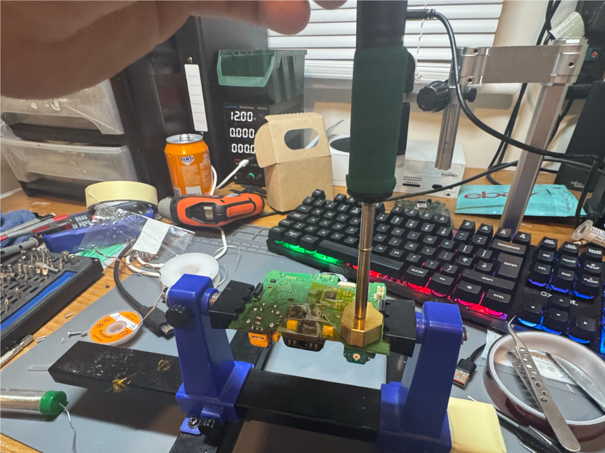 Xbox One controller circuit board secured in a repair jig during a TMR joystick upgrade