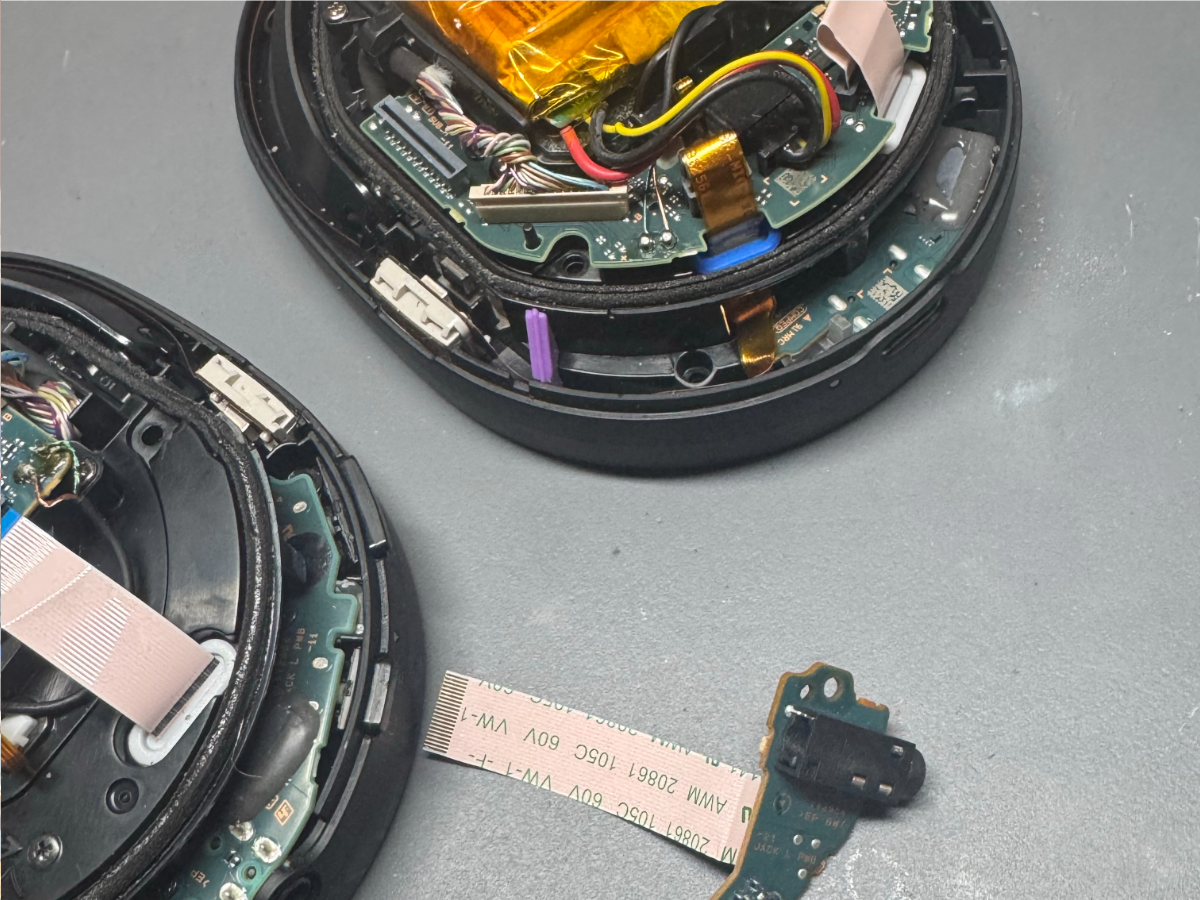 isassembled Sony WH-1000XM5 headphones with the power board removed