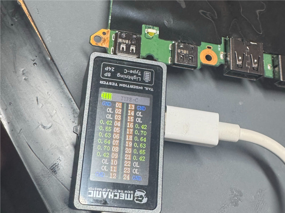 Lenovo X1 laptop USB-C port board connected to a tester during repair